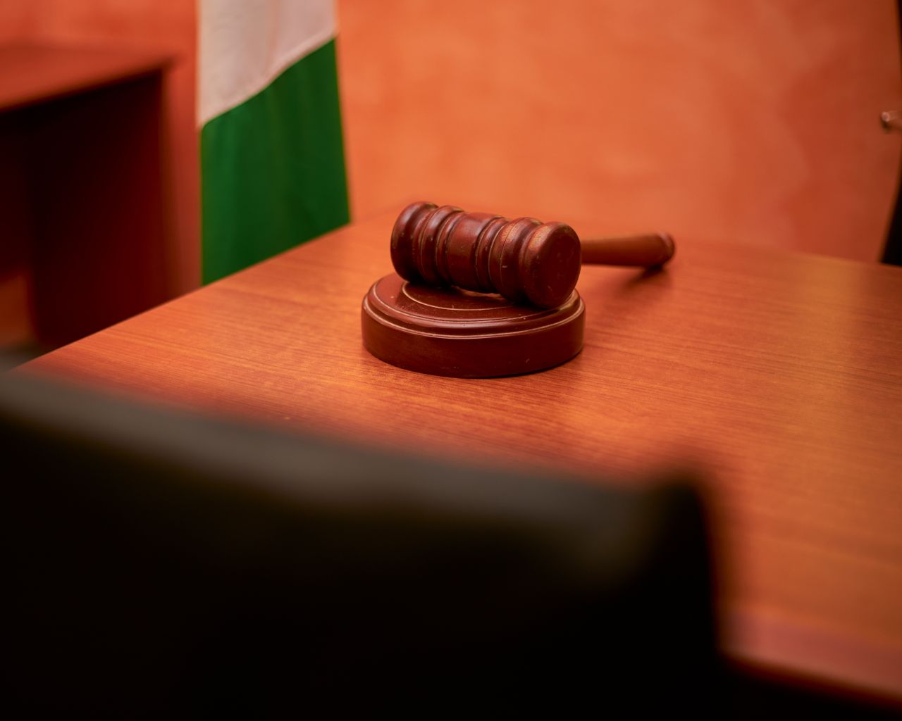 services-03 A close-up of a gavel on a courtroom desk representing law and justice.