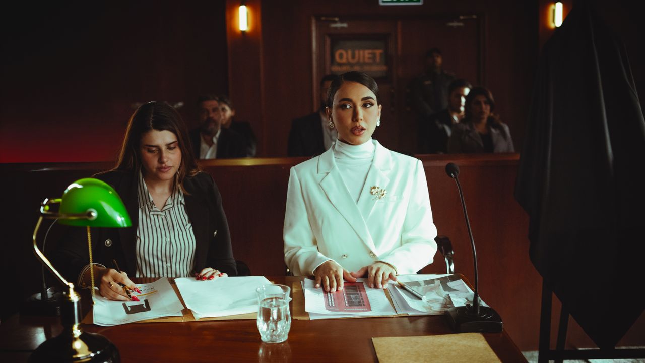 about-us Two female lawyers in a courtroom setting, focusing on legal documents and poised presentation.